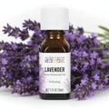 Aura Cacia Lavender Essential Oi with a bouquet of lavender behind it