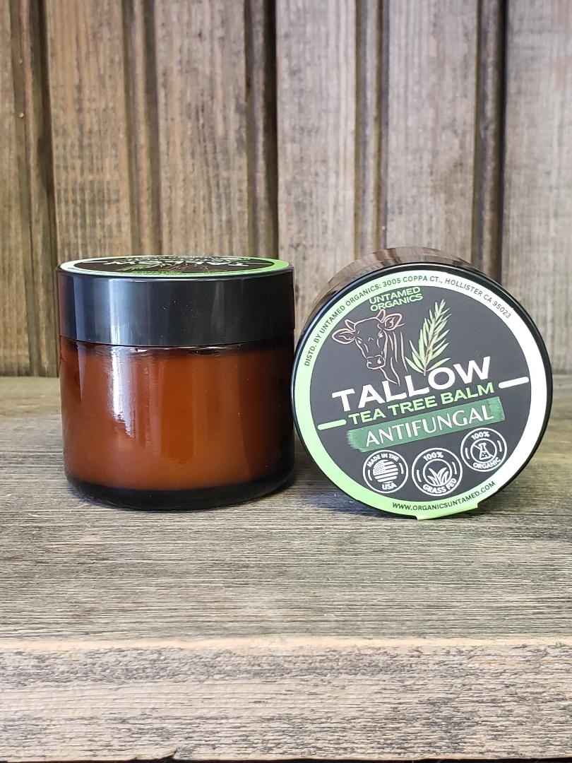 Tallow tea tree balm jar and container on a wooden surface