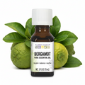 Aura Cacia Bergamot essential oil bottle with bergamot behind