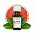 Aura Cacia Grapefruit essential oil with cut grapefruit behind
