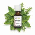 Bottle of Aura Cacia essential oil with patchouli in the background