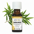 Aura Cacia Sandalwood Essential Oil in Jojoba Oil with sandalwood behind bottle