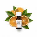 Aura Cacia Sweet Orange Essential Oil with oranges behind bottle