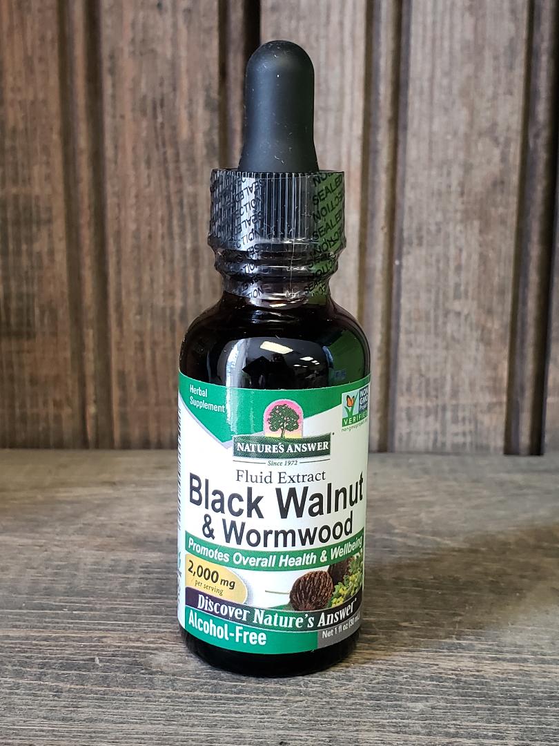 Bottle of Black Walnut & Wormwood extract on a wooden surface