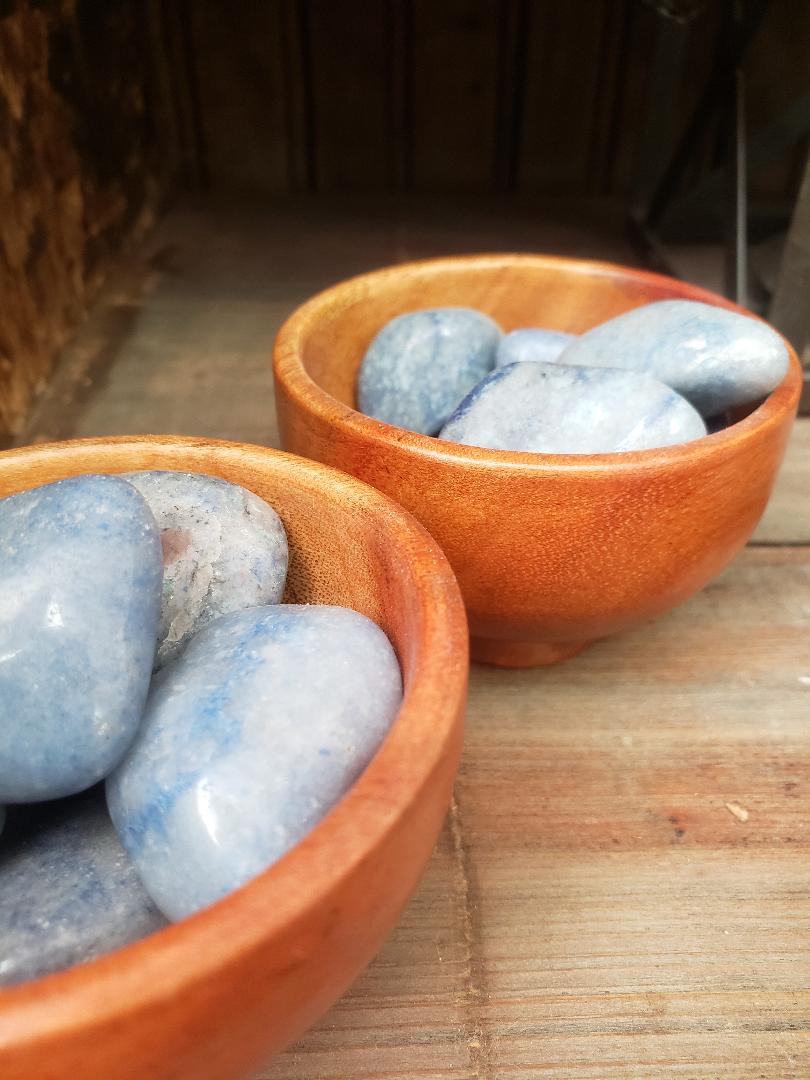 Blue quartz in wooden bowls on a rustic table