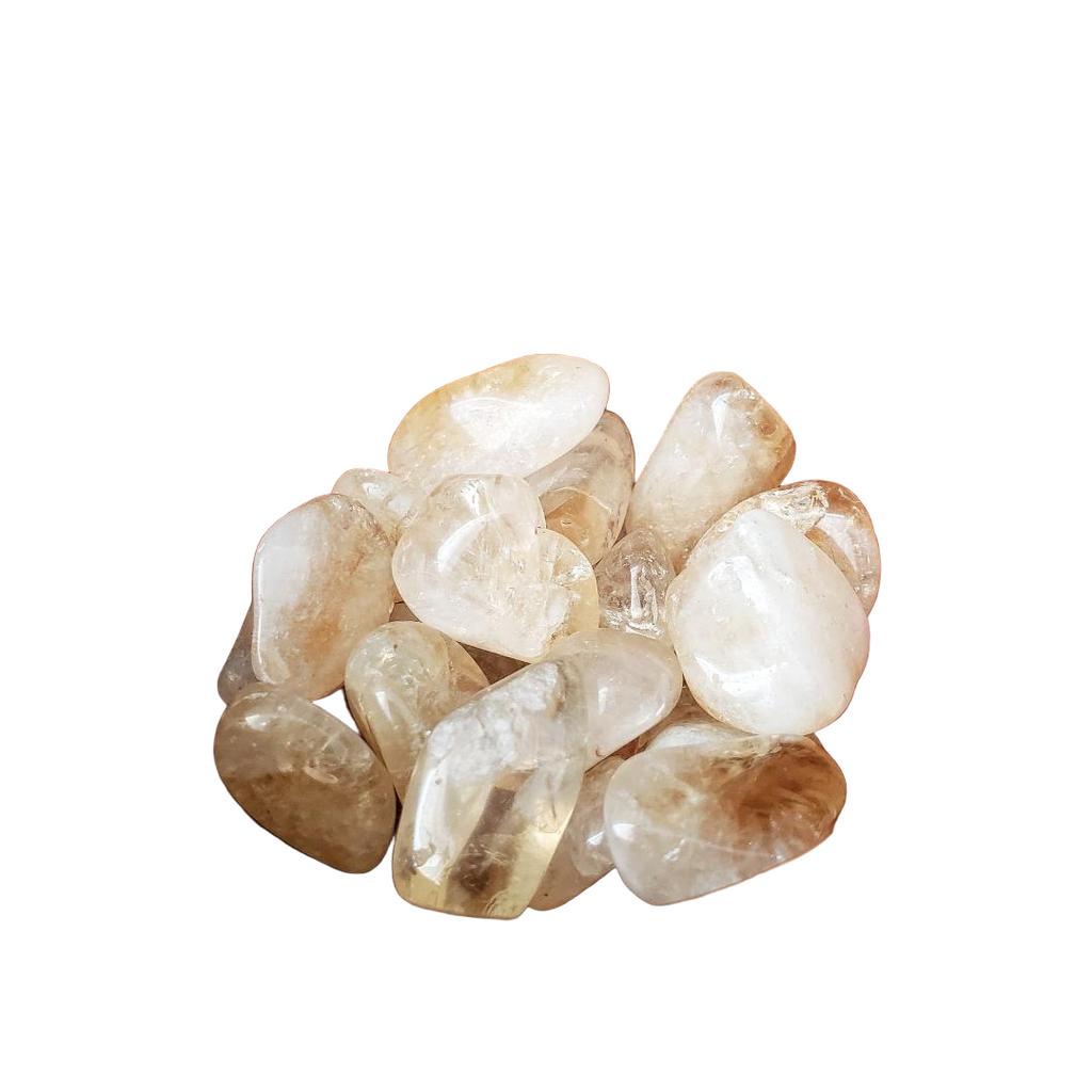 Pile of polished citrine stones on a white background