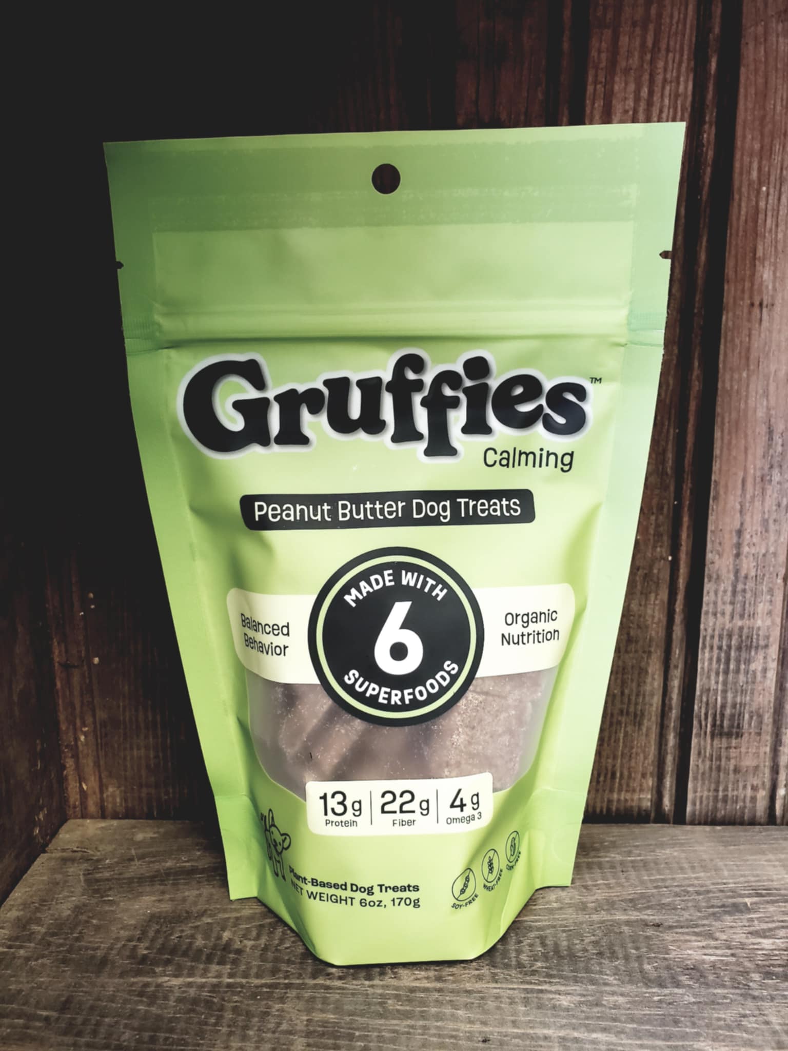 Green package of Gruffies Calming Peanut Butter Dog Treats on a wooden surface