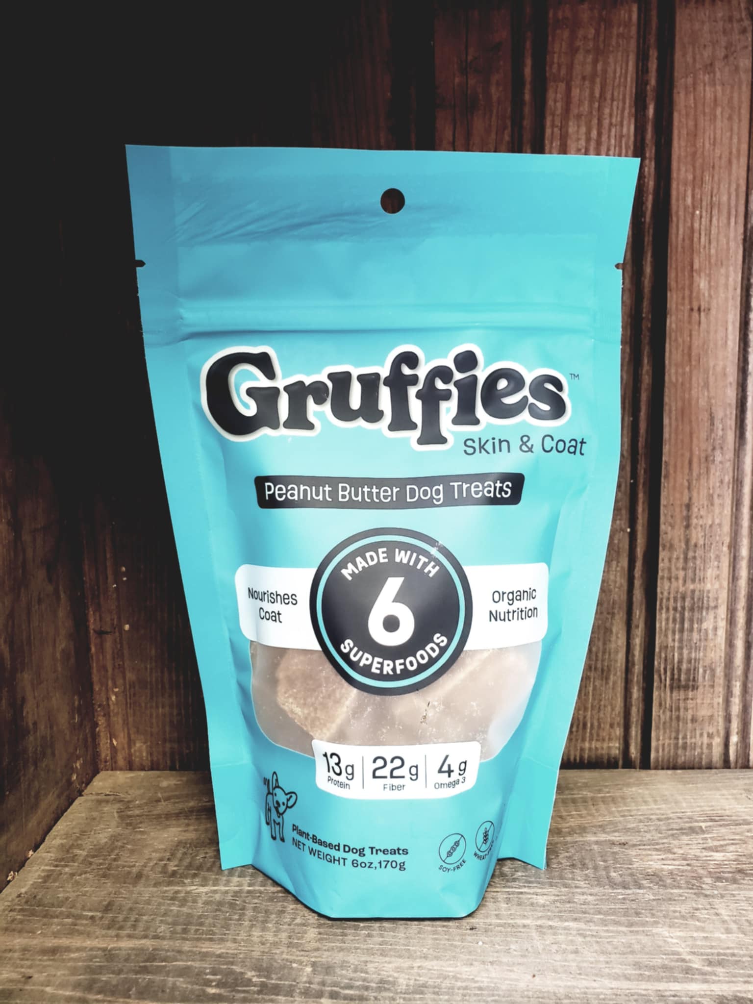 Gruffies peanut butter dog treats package on a wooden surface