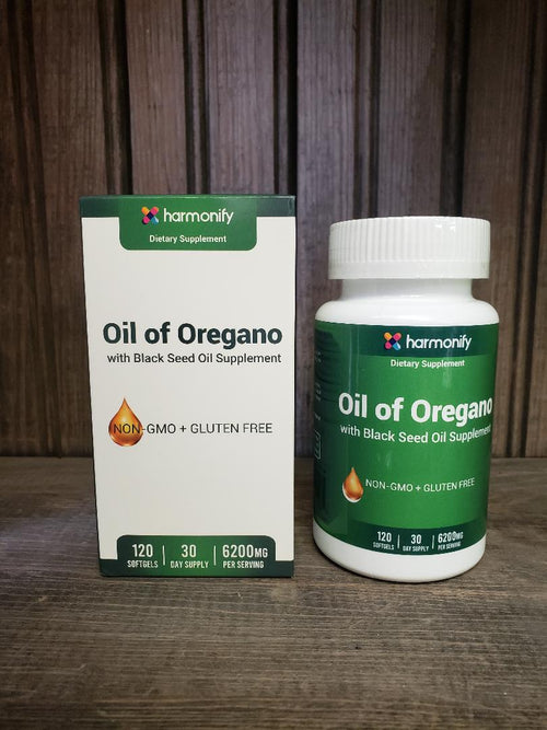 Harmonify Oil of Oregano supplement bottle and packaging on a wooden surface