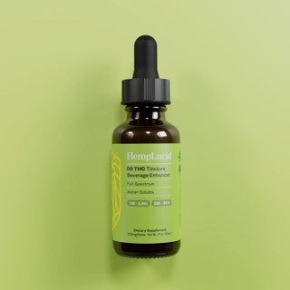 Bottle of HempLucid 10:1 water soluble drops on a green background
