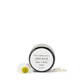 A jar of Mama's Medicinals Baby Bum + Body Balm with a white label, surrounded by a chamomile flower and some petals on a white background.