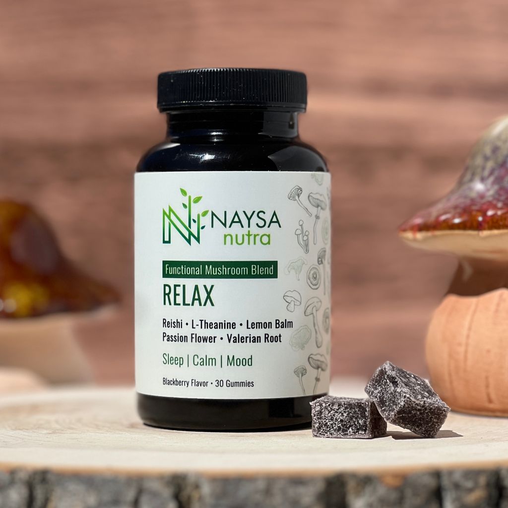 Naysa Nutra Relax gummies on a piece of wood next to ceramic mushrooms