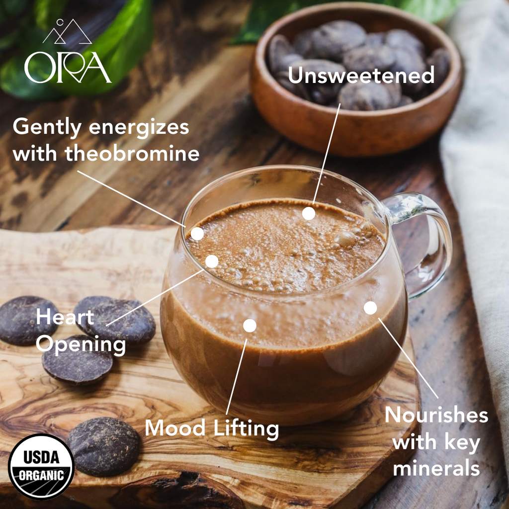 Glass of chocolate drink with health benefits labeled on a wooden surface, featuring the Ora brand.