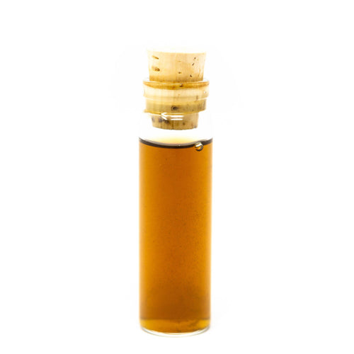 stopper bottle with amber liquid on a white background