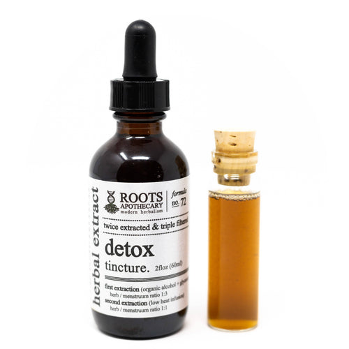 Roots Apothecary detox tincture bottle with dropper and smaller sample bottle on a white background