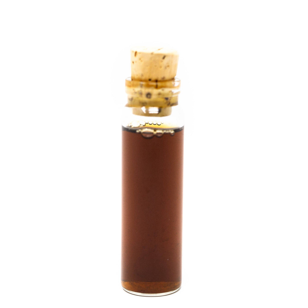 Small glass bottle with cork stopper on a white background