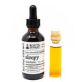 Bottle of Roots Apothecary sleepy tincture with dropper and small vial of liquid on a white background