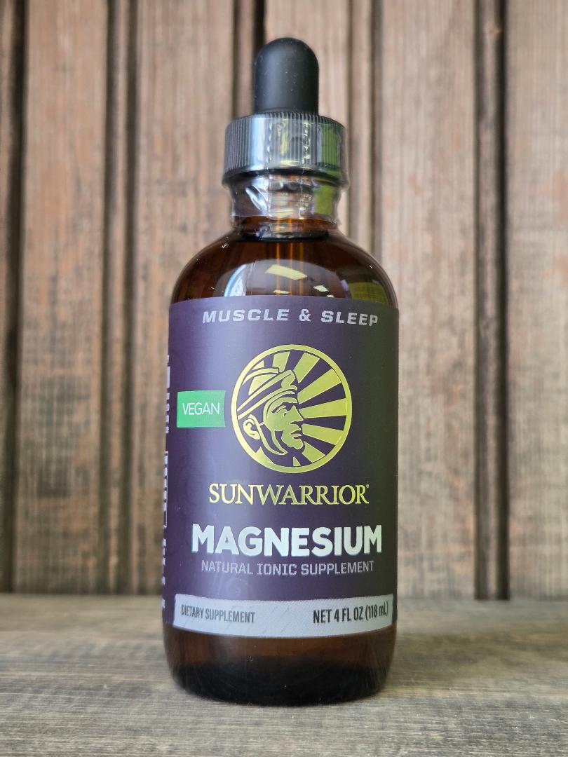 Sunwarrior magnesium supplement bottle on a wooden surface