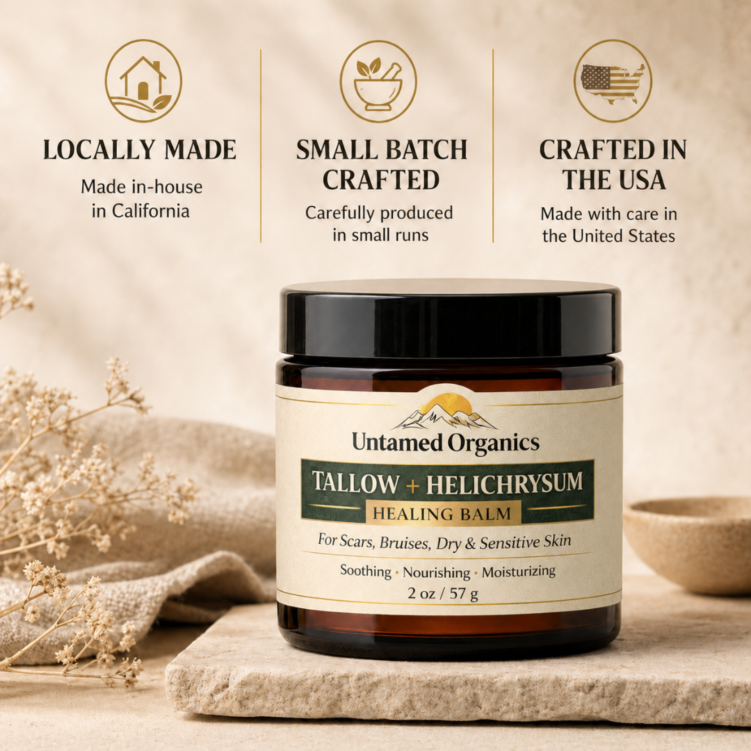 Jar of Untamed Organics Tallow + Helichrysum Healing Balm with branding and product details on a neutral background.