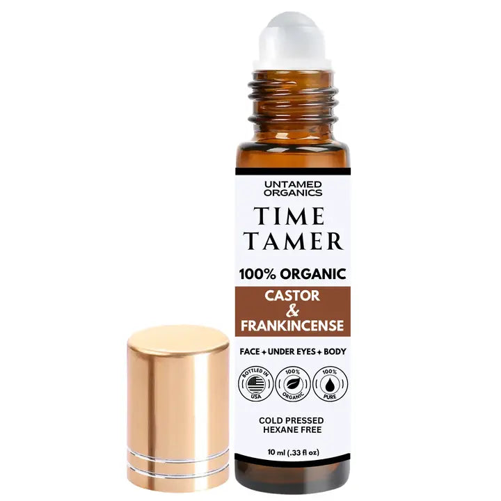 Roll-on bottle of 'Time Tamer' by Untamed Organics with gold cap and white label on a white background