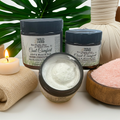 Wild Herb Cool Comfort Joint & Muscle Rub with a candle and salt in the background